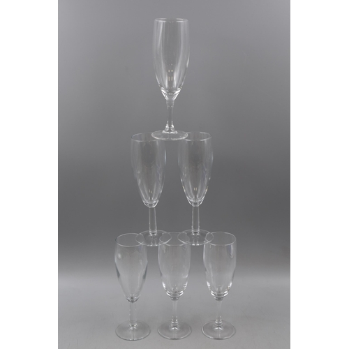 206 - A Selection of Nine Coloured Glass Bowls and Six Clear Glass Champagne Flutes.