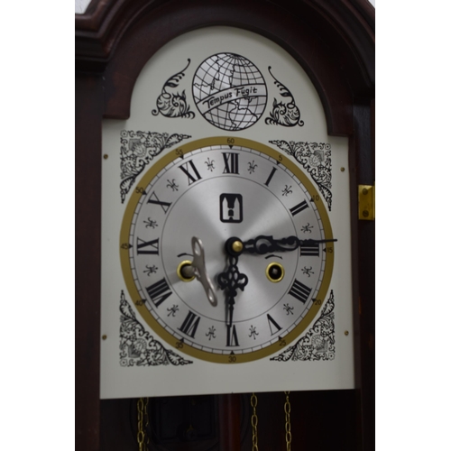 596 - Wood Cased Wall mounted Clock Complete with key, pendulum, and weights (28