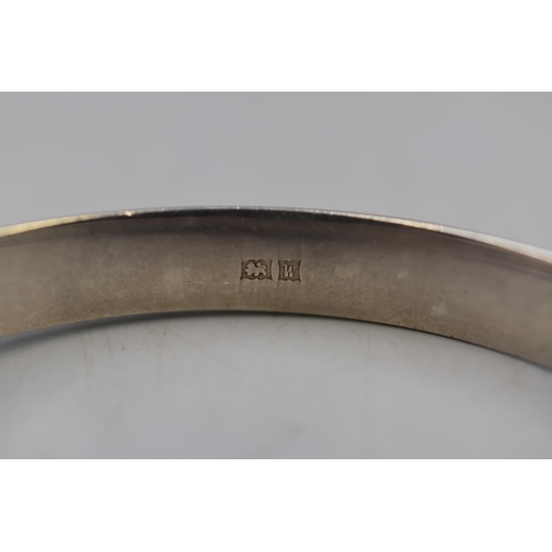 24 - An Etched Hallmarked Birmingham Silver Bangle, With Safety Chain. Circa 1971.