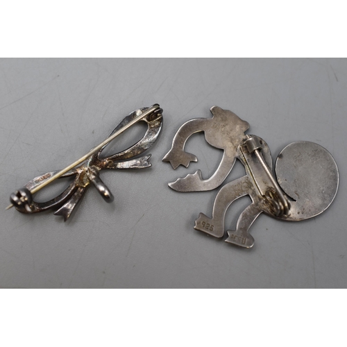 25 - Two Silver Brooches. Includes Silver Bow Brooch and 925. Peru Silver Monkey Brooch.