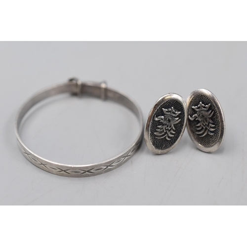 54 - An Etched Sterling Silver Child's Bangle, With a Pair of Eagle Cufflinks (Some Markings).