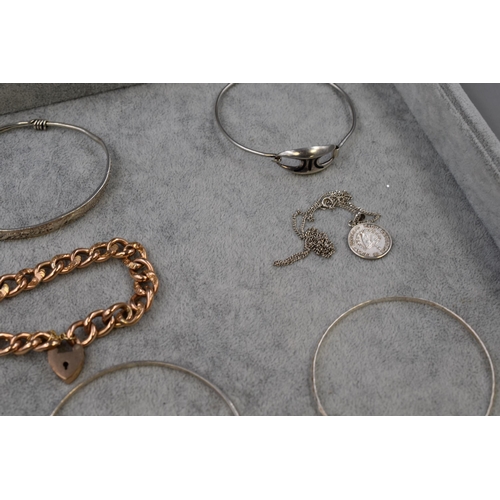 62 - Selection of Silver Bangles, Necklaces, and a unmarked Curb Linked Bracelet