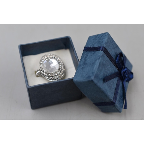 50 - An 18k Gold Plated Clear Stoned Ring, Size R. In Presentation Box