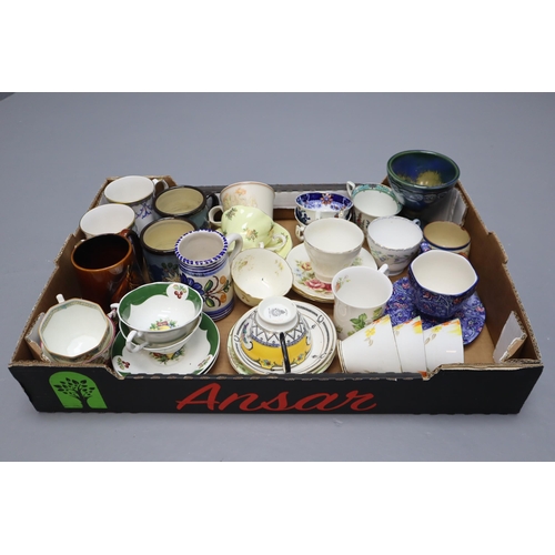 693 - A Large Selection of Mixed Ceramic Cups and Saucers. Includes Ringtons, Adderley, Paragon, Royal Gra... 