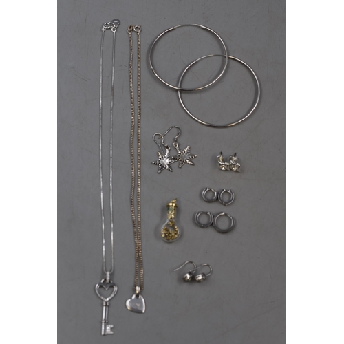 63 - Mixed Selection of Jewellery items, includes Two Silver Necklaces and a Selection of Earrings.