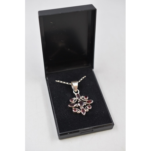 64 - A 925. Silver Garnet Stoned Flower Pendant on 925. Silver Belcher Chain. In Presentation Box.