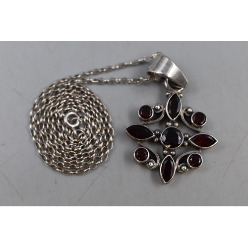 64 - A 925. Silver Garnet Stoned Flower Pendant on 925. Silver Belcher Chain. In Presentation Box.