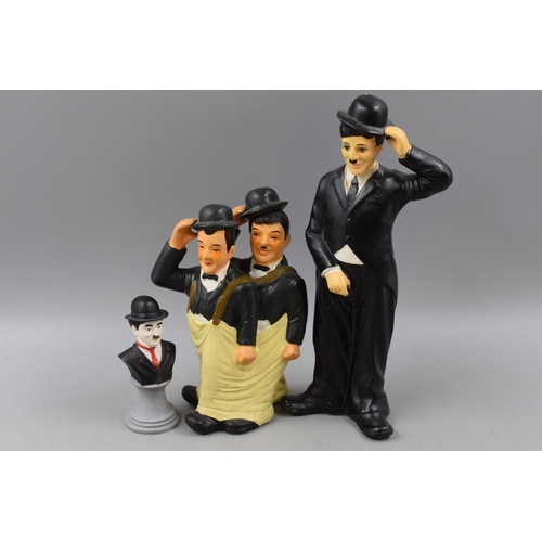 304 - Two Charlie Chaplin and one Laurel an Hardy Figures