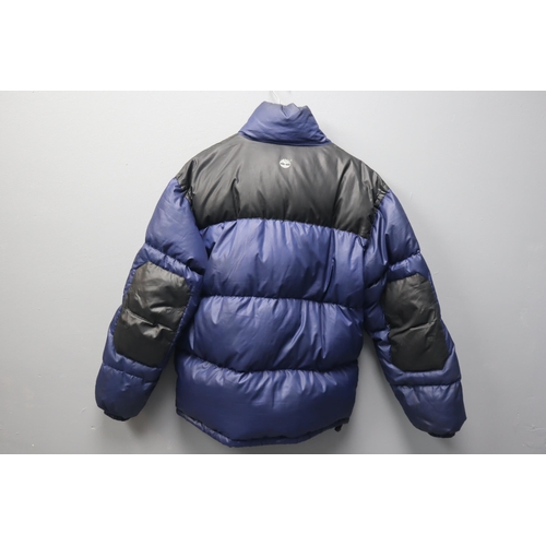 595 - A Timberland Performance Blue and Black Puffer Jacket. Size L.