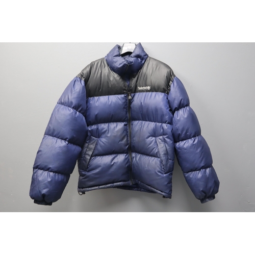 595 - A Timberland Performance Blue and Black Puffer Jacket. Size L.