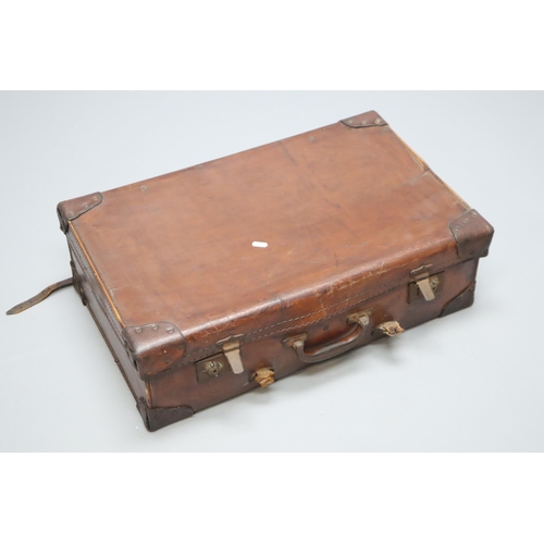 702 - A Vintage Leather Effect Travel Suitcase. Approx 16.5