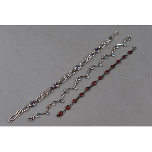 35 - Three Sterling Silver Bracelets. Includes Ladybird, Purple Stoned and Blue Stoned.