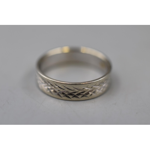 57 - An 18ct White Gold Etched Band Ring, Size L. Approx 2.89g.