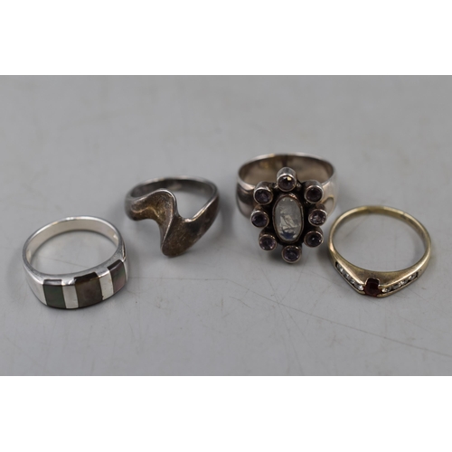 91 - A Selection of Four 925. Silver Rings. Includes Red and Clear Stoned Gold Tone Ring, Silver Wavy Rin... 