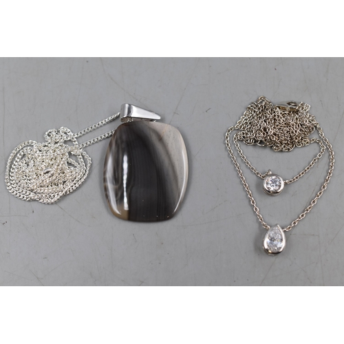 93 - A 925. Silver Clear Stoned Necklace With a 925. Silver Marble Effect Pendant on Silver Chain. With P... 