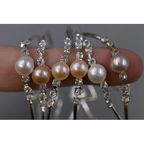 130 - A Selection of Six Pearl and Clear Stoned Designer Bracelets.