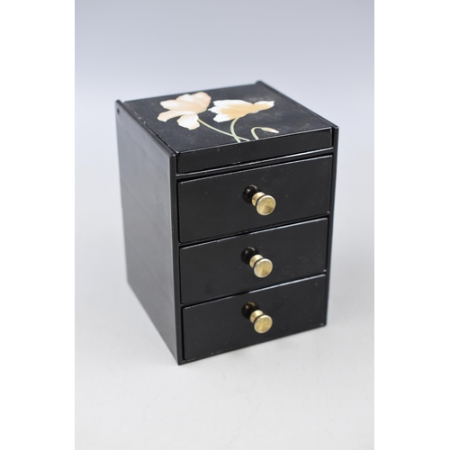 131 - A Three Drawer Black Floral Jewellery Box With a Selection of Unsorted Jewellery.