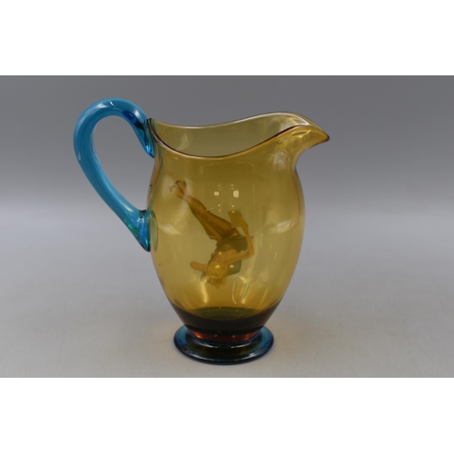 270 - A Mid Century Blue and Amber Glass Jug, With Transfer of Blonde Lady. Approx 8.5