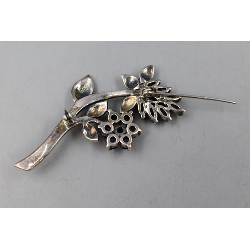 11 - A Sterling Silver Marcasite and Amethyst Floral Brooch, Some Stones Missing.