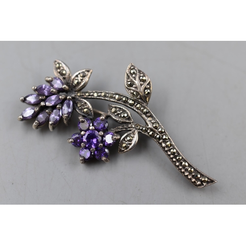 11 - A Sterling Silver Marcasite and Amethyst Floral Brooch, Some Stones Missing.