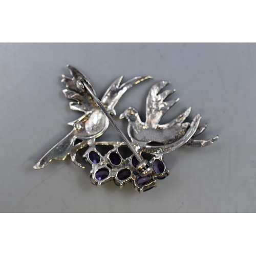 16 - A Sterling Silver Marcasite and Amethyst Stoned Brooch, Showing Two Doves on a Branch.