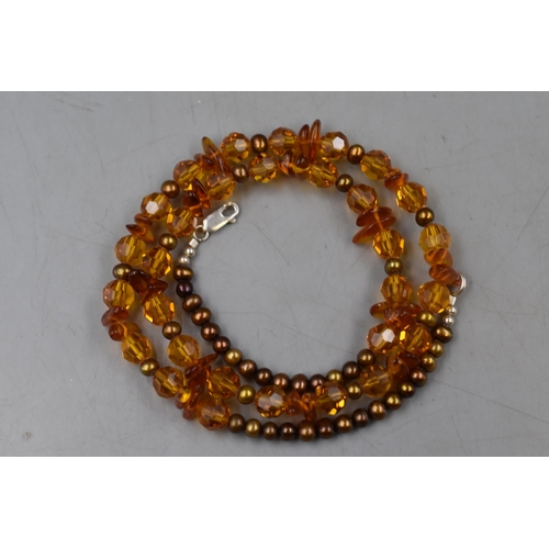 73 - An Amber and Pearl Beaded Necklace, With Sterling Silver Clasp