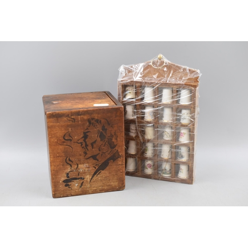 280 - Vintage wooden tea caddy with Buckfast Abbey Spoon and a selection of thimbles in Display