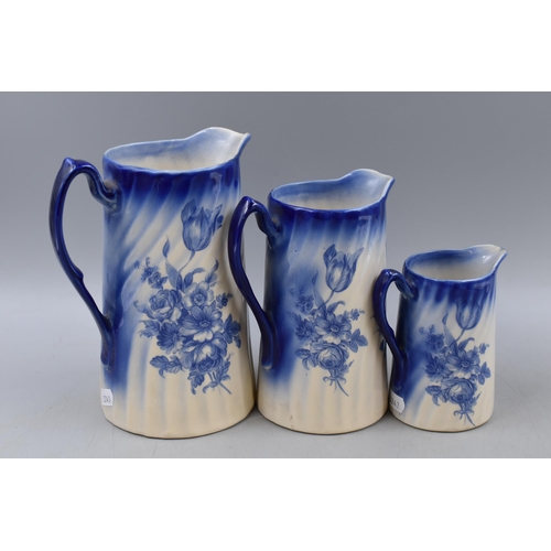 295 - Three Mid Century Graduating Blue and White ceramic Water Jugs largest 8