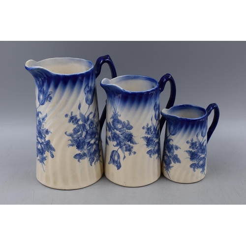 295 - Three Mid Century Graduating Blue and White ceramic Water Jugs largest 8