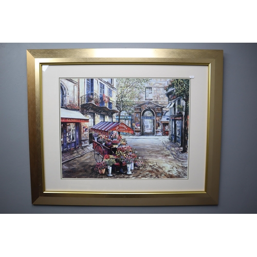 312 - A Framed and Glazed Print Titled 'Fleurs De La Ville ', Depicts French Town Scene. Approx 34.5