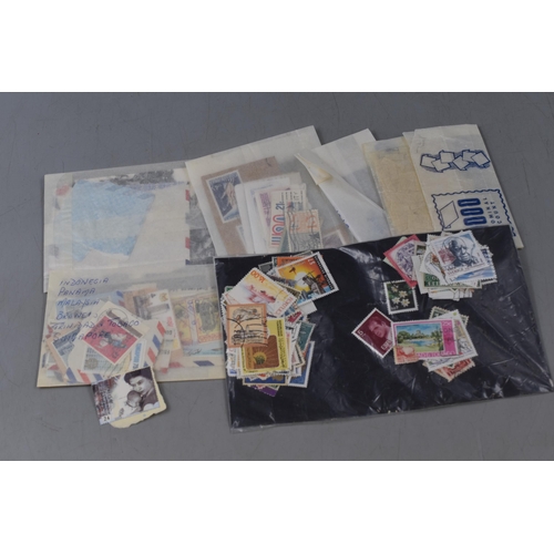 414 - Large Selection of Mixed Worldwide Stamps and a Stanley Gibbons Stamps of The World Catalogue