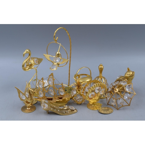 715 - Eleven Pieces of 24k Gold Plated Crystal Temptations Figures. Includes Ship, Pineapple, Umbrella, Ca... 