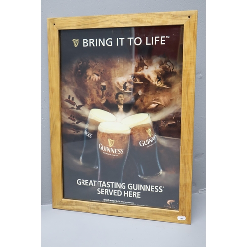 391 - Two Guinness Promotional Posters Mounted in Ash Wooden frames (Largest 35