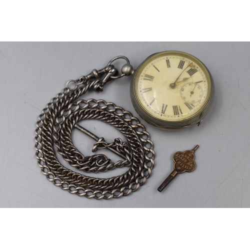 212 - An Antique Pocket Watch With Sterling Silver Albert Chain, And Key. In Working Condition