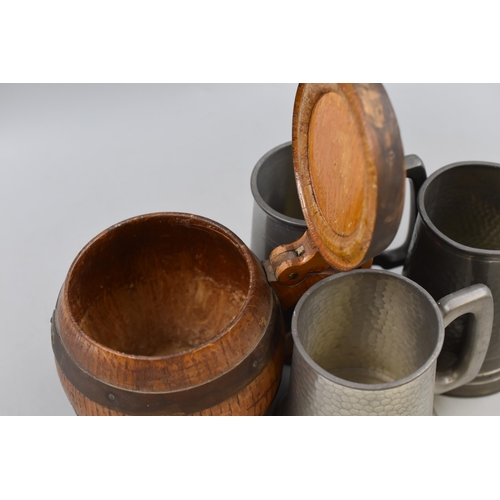 240 - Four Tankards. To Include Three Pewter Tankards, And One Whiskey Barrel Style Tankard