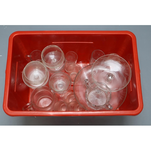 864 - A Large Selection of Clear Glassware. Includes Cut Glass Pitcher, Cake Stand, Etched Glassware, And ... 