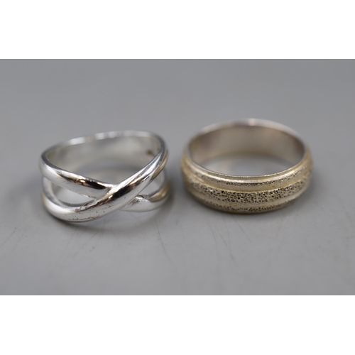 10 - Two Sterling Silver Rings. Includes Etched Band Ring, And Cross Ring