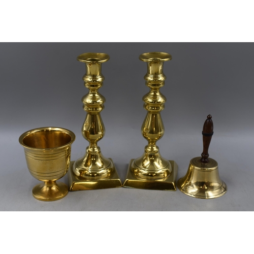 334 - Four Pieces of Brassware. Includes Pair of Brass Candlesticks, Brass Bell, And Goblet