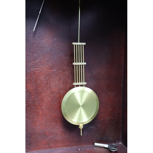 658 - A Maxim 31 Day Wood Cased Wall Clock, With Key. In Working Condition, Approx 31