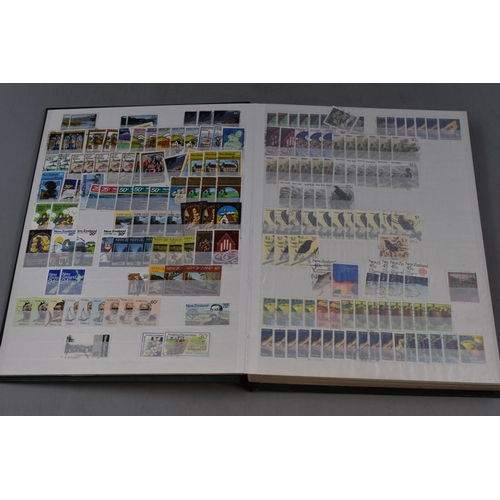 512 - A Stock Book Containing a Large Collection of New Zealand Stamps