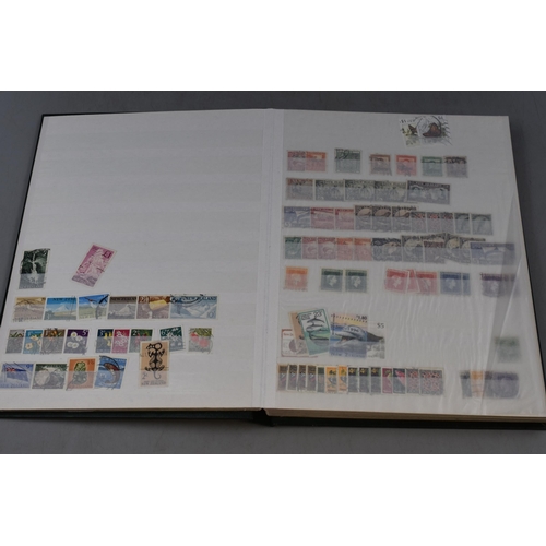 512 - A Stock Book Containing a Large Collection of New Zealand Stamps