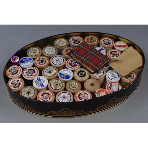 322 - Selection of sewing items to include vintage floral design tin containing vintage cotton reels and a... 