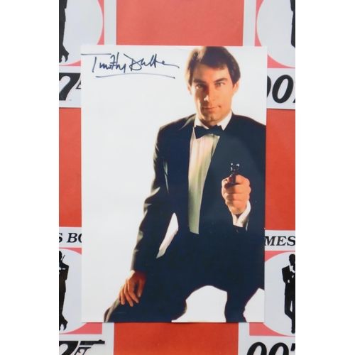 383 - Framed and Glazed Collection of James Bond Printed Photographs with printed signatures 20