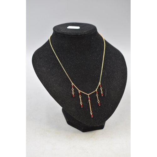 1 - A 9ct Gold Red Stoned Tassel Necklace