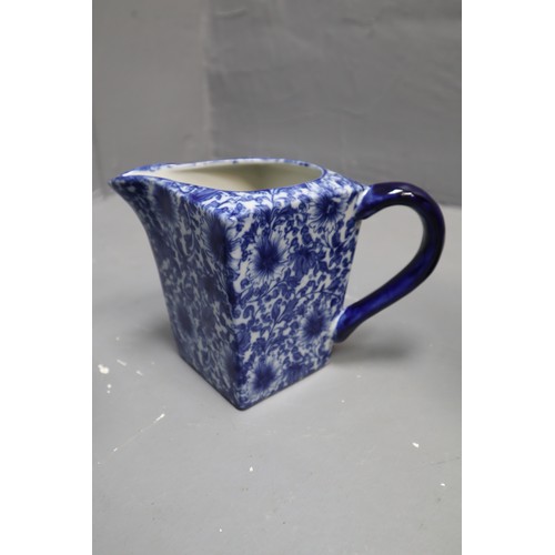 399 - Three Blue and White Pottery items to include Staffordshire Jugs and unmarked Floral Vase