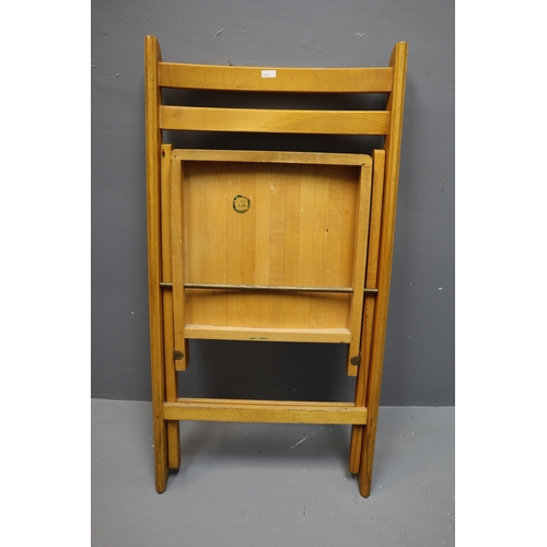 609 - Four quality folding light wood chairs