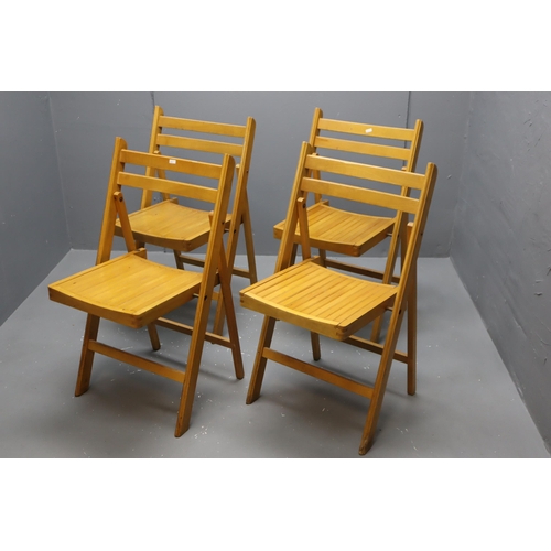 609 - Four quality folding light wood chairs