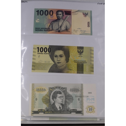 237 - Folder Containing a Large Selection of Worldwide Uncirculated Bank Notes. Includes Cambodia, Banglad... 