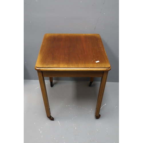 657 - Small square vintage wooden table on castors measures 24