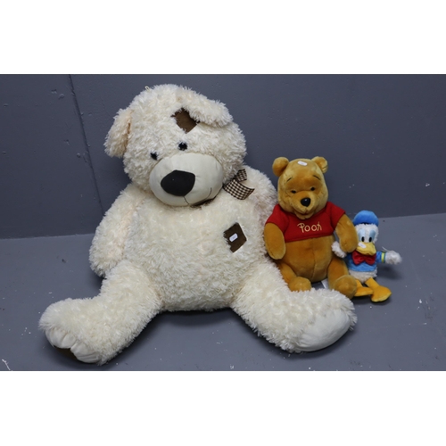 858 - A Selection of Three Soft Toys To Include Donald Duck, Winnie The Pooh, And Large Patchwork Bear